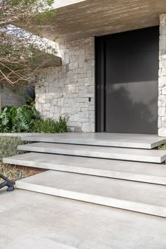 some steps leading up to a building with a black door