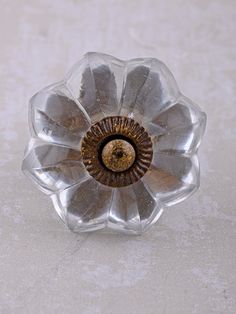 a glass flower shaped object sitting on top of a table