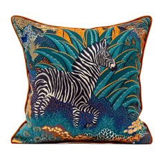 a decorative pillow with a zebra on it's side and plants around the edges