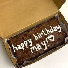 a birthday cake in a box with the words happy birthday may written on it's side