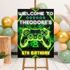 a video game birthday sign in front of balloons