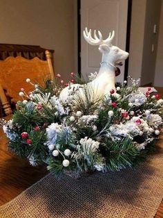 a christmas centerpiece on a dining room table