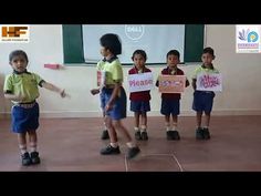 children holding signs in front of a class room