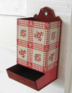 a red and white checkered box hanging on the wall