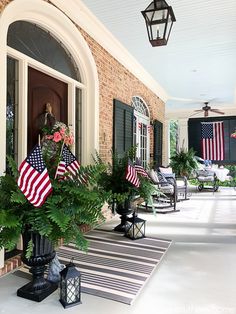 an american flag is displayed on the front porch