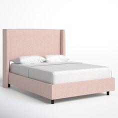 a bed with a pink headboard and two pillows on it's sides, against a white background