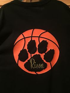 a black shirt with an orange basketball and the word ron written in gold on it