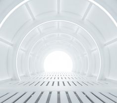 an empty white tunnel with light coming in from the center and floor to the other side