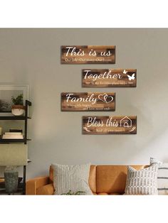 three wooden signs hanging on the wall above a couch