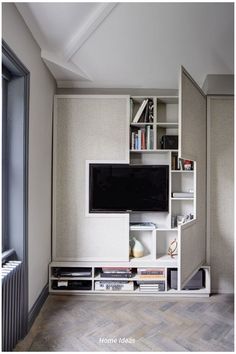 an entertainment center with bookshelves and television