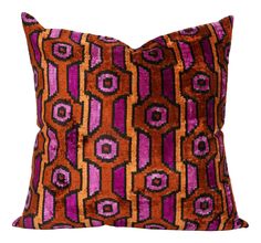 an orange and purple pillow on a white background