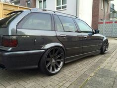 a black car parked in front of a house