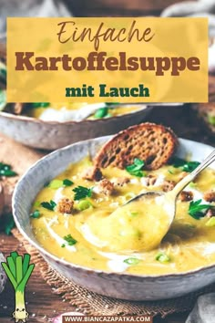 a bowl of soup with bread and parsley in it, on top of a wooden table