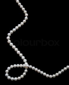 a single strand of white pearls on a black background with the word x spelled out