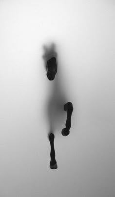 a person standing in the middle of a foggy room with their legs up and feet down