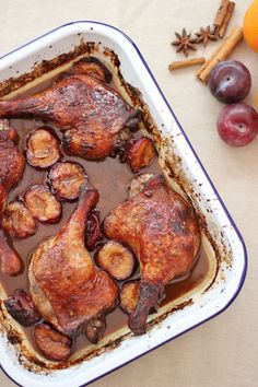 a roasting pan filled with meat and fruit