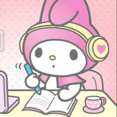 a hello kitty character sitting at a desk with a notebook and pen in front of her