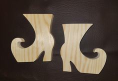 two wooden letters that are on top of a black leather surface and one is shaped like the letter k