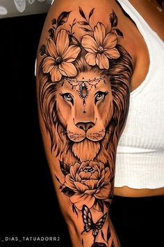 a woman's arm with a lion and flowers on it