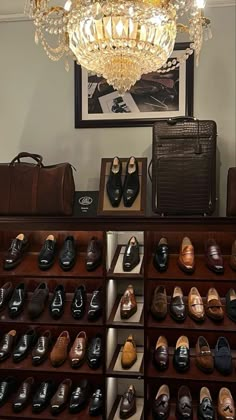 a chandelier hanging from the ceiling in a room filled with shoes