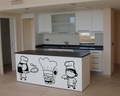 an island in the middle of a kitchen with stickers on it's side