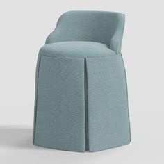 an upholstered chair with a curved back and seat, in light blue fabric