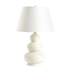 a white lamp sitting on top of a table