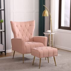 a pink chair and footstool in a living room with a gold floor lamp