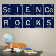 the science rocks wall decal is shown above a desk with books and an earth globe