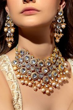 Baroque Pearl & Polki Necklace Set - Joules By Radhika Capture hearts on your wedding day with our 22KT Gold Plated necklace set. The enchanting Hydro Polkis, exquisite baroque pearls, and alluring Agate Beads unite in perfect harmony. This captivating ensemble complements your bridal charm, radiating sophistication and grace. SET INCLUDES: Necklace and Earrings Details: Handcrafted with ❤️ Metal: Brass Product Type: Choker Stone: Hydro Polkis, baroque pearls, Agate Beads Plating: 22K Gold Plati Elegant Festive Jewelry Sets For Reception, Elegant Kundan Jewelry With Intricate Design, Luxury Wedding Jewelry Sets, Exquisite Kundan Jewelry For Reception, Elegant Pearl Jewelry Sets For Wedding, Elegant Pearl Bridal Sets With Pearl Drop, Elegant White Bridal Sets With Pearl Drop, Kundan Jewelry Sets With Elegant Design, Luxury Gold Pearl Necklace For Wedding