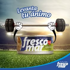 a can of fresco mar with a barbell on it in front of a stadium