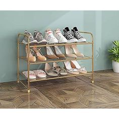 several pairs of shoes are on a gold shoe rack