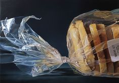 two plastic bags filled with sandwiches sitting on top of a black table next to each other