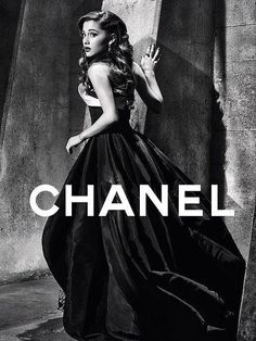 a black and white photo of a woman in a dress with the words chanel on it