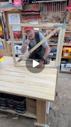 a man working on a wooden table in a shop