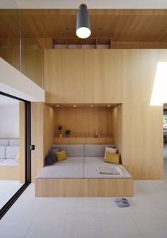 an open living room with wooden walls and white flooring