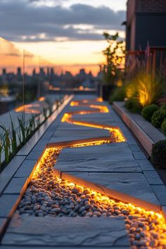 the walkway is lined with stones and lit up by led lights at sunset or dawn