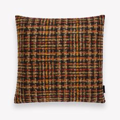 a brown and black plaid pillow on a white background