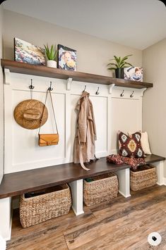 a bench with baskets and coat hooks on it