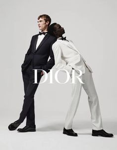 two men in tuxedos pose for dior