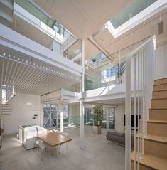 a large open living room with stairs leading up to the second floor and an indoor dining area