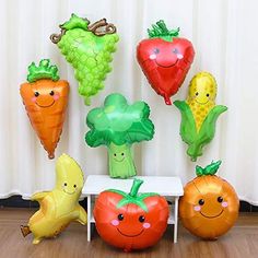 there are many balloons in the shape of fruits and vegetables