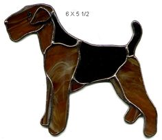 a brown and black dog standing on top of a white surface