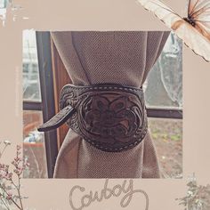 a brown belt with an ornate design on it and the words cubby written in cursive writing