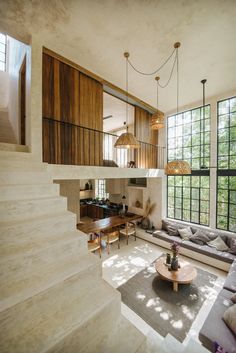 a living room filled with furniture and windows