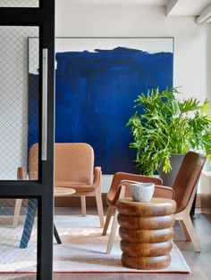 a living room filled with furniture and a painting on the wall