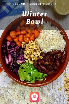 a bowl filled with lots of different types of food on top of a white table