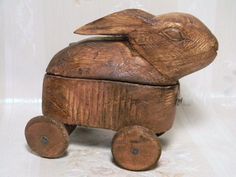 a wooden toy rabbit sitting on top of a table