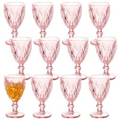 a set of twelve pink glass goblets with gold rims on each one