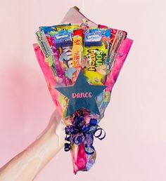 someone holding up a star shaped candy bouquet